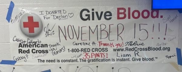 Blood drive poster with signatures of students and teachers who donated.