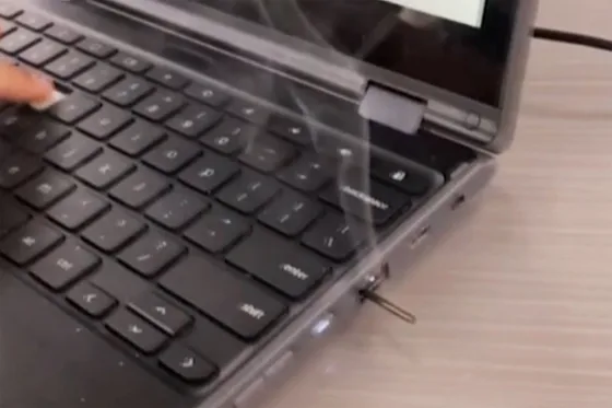 A Chromebook smoking after being tampered with 
