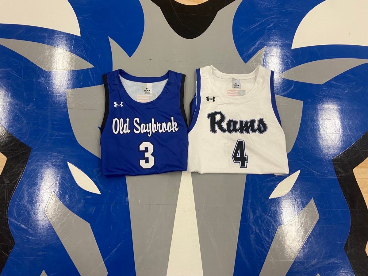 The new jerseys for the boys basketball team rest on the Ram logo on the OSHS gym floor. 

