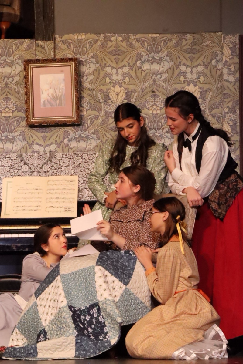 The March family, from left to right: Tess Santarsiero (Amy March), Mikayla Pace (Marmee), Shelby Pauloski (Meg March), Maggie Stanley (Beth March), Samantha Walsh (Jo March), perform on November 14, 2025.
