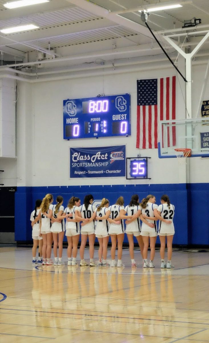 Girls Basketball standing for the National Anthem     