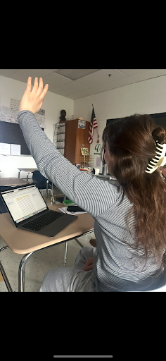 Senior Marie-Therese Morosky raises her hand in News Media Now Class
